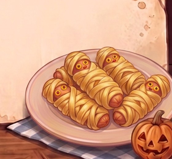A painted plate of golden mummy hot dogs wrapped in crisscrossed dough strips, with yellow mustard eyes and red ketchup pupils, beside a small carved pumpkin on a blue checked cloth.